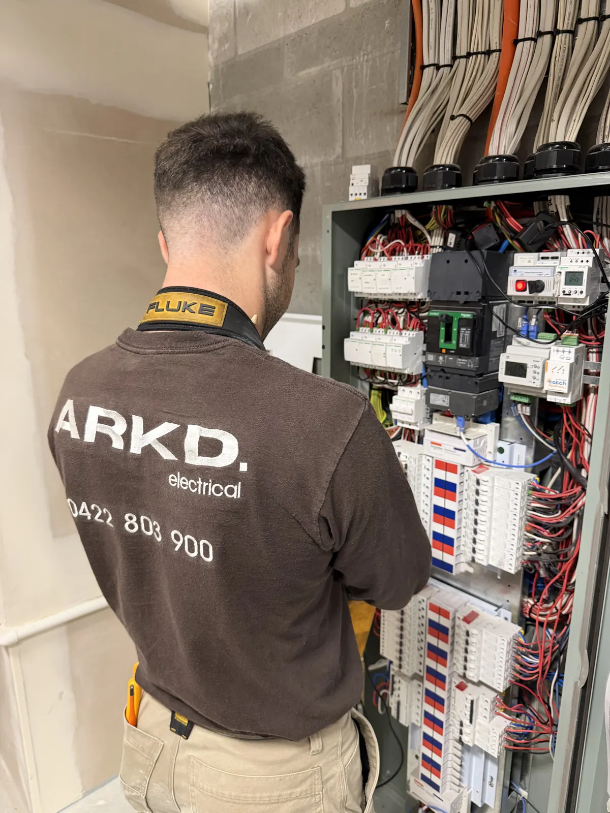 ARKD commercial electrician working on a multi-circuit switchboard in Brisbane